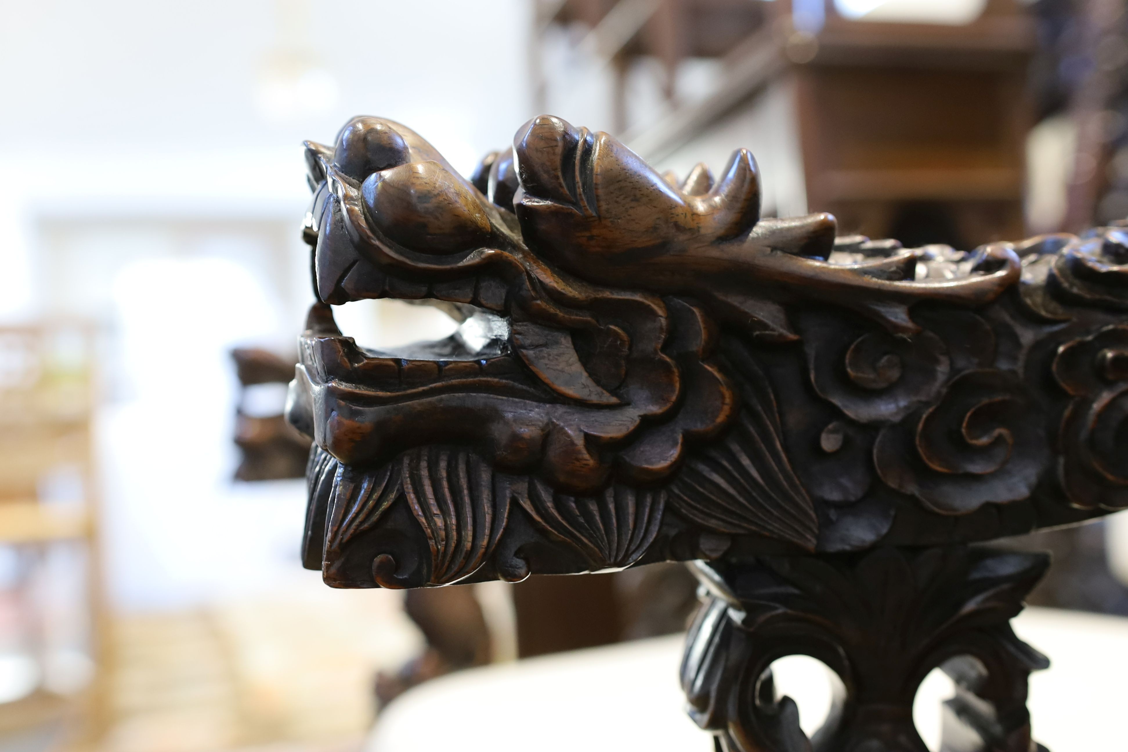 A good Chinese hardwood ‘dragon’ throne armchair, c.1900, 114.5cm high, 68cm wide at the arms